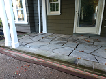 Natural stone patio with natural stone risers & stamped colored concrete patio with service walk